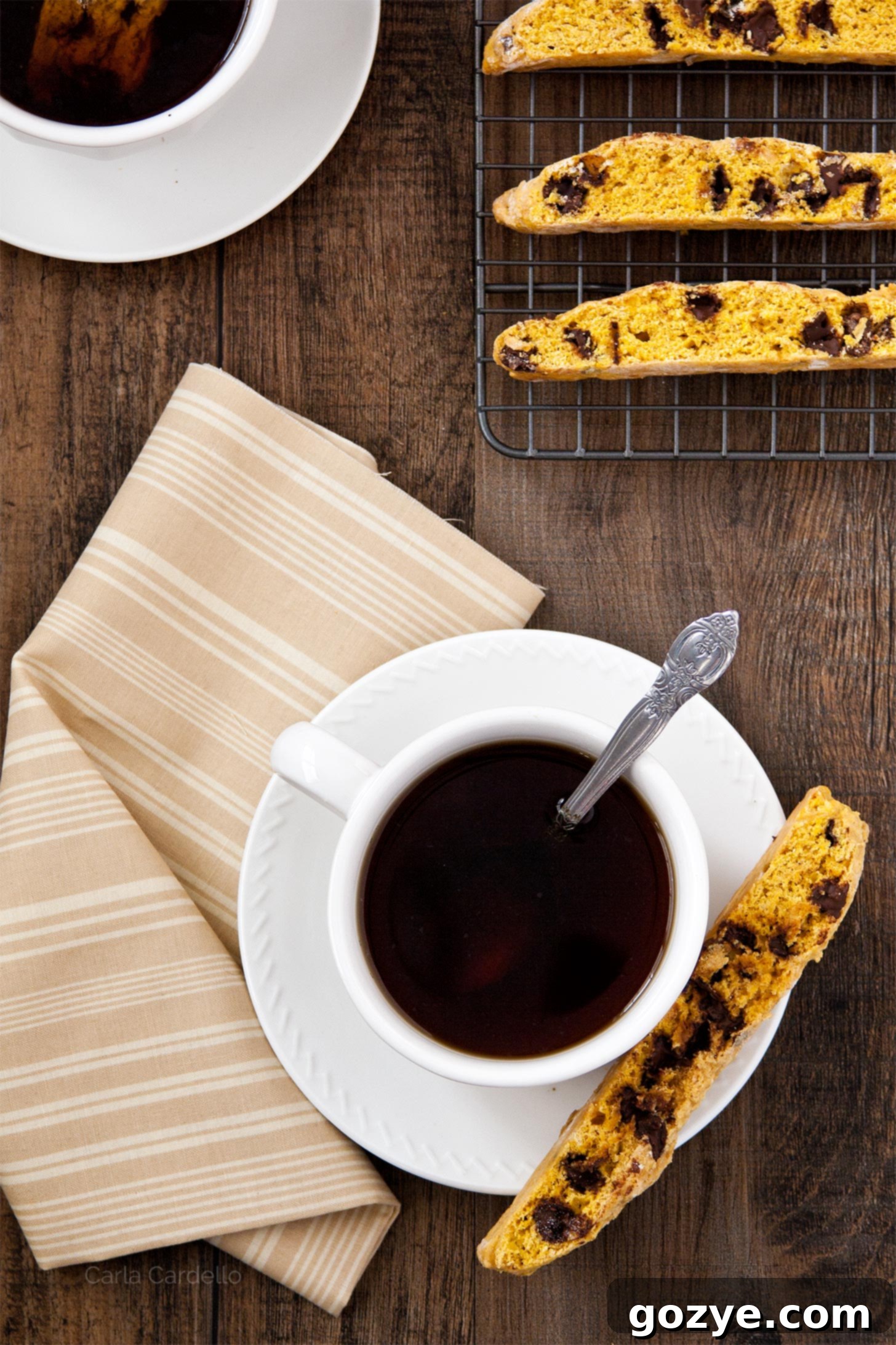Pumpkin biscotti served with a cup of coffee, ready for dunking.