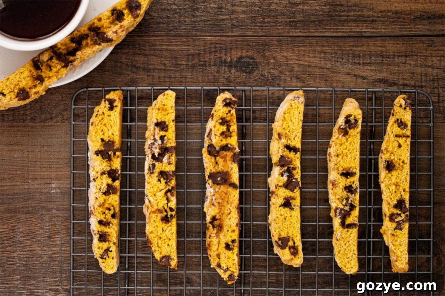 Close-up of freshly baked pumpkin biscotti cooling on a wire rack.