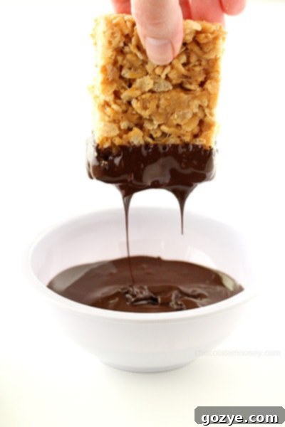 Dipping Small Batch Peanut Butter Rice Krispie Treats in chocolate