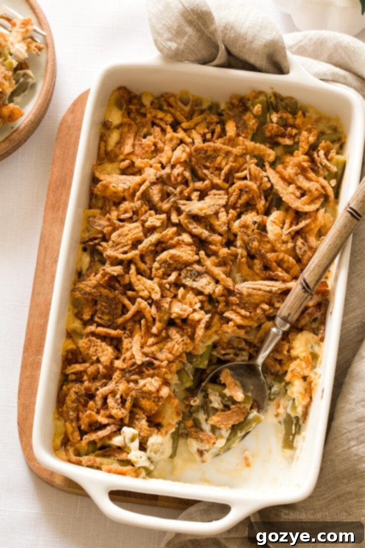 Homemade green bean casserole with a serving spoon, ready to dish out