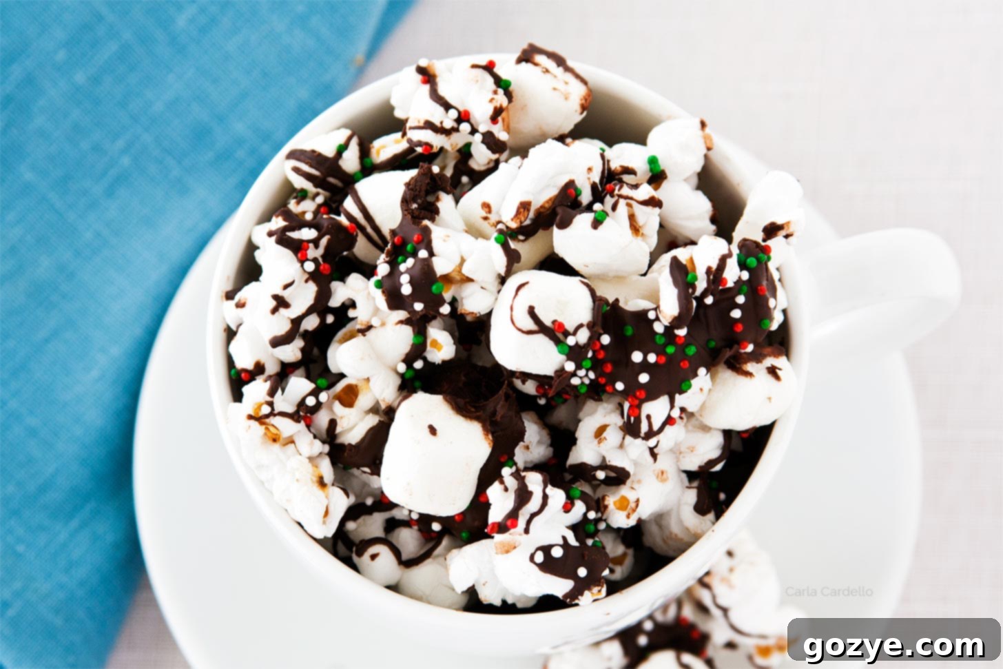 Sweet & Salty Popcorn Crunch 4 Chocolate drizzled popcorn in a white mug