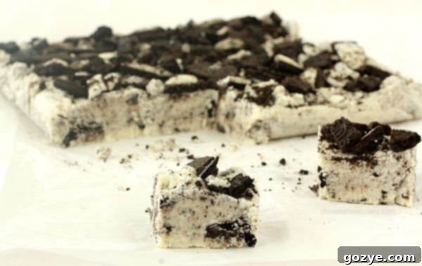 Delicious Oreo Fudge squares on a cooling rack, showing the creamy texture and cookie pieces.