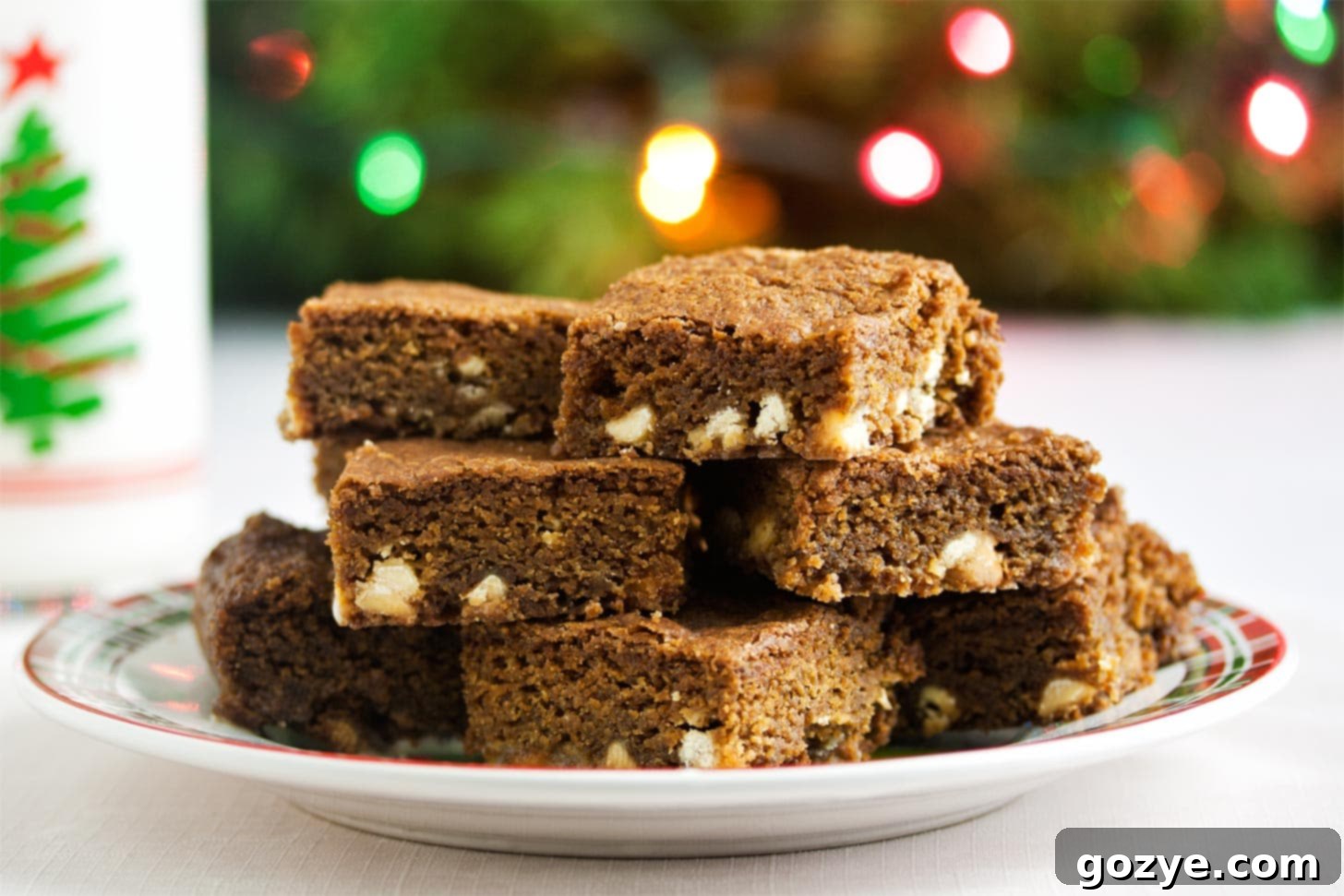 Warm Spice Blondie Bars 4 Close up of gingerbread blondies on plate with glass of milk