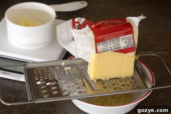 Grating Kerrygold Irish Cheese, preparing for the popcorn recipe