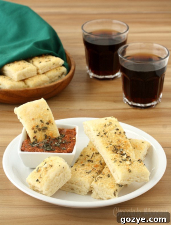 Soft Garlic Parmesan Breadsticks (Pizza Hut Style) with Pepperoni Dipping Sauce, freshly baked on a baking sheet