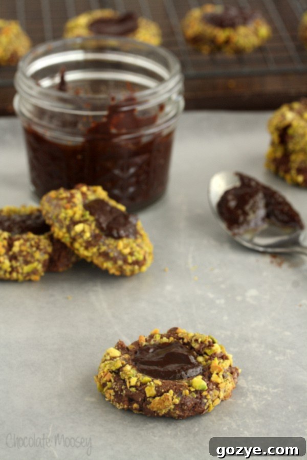 A batch of delicious thumbprint cookies cooling on a wire rack, ready for ganache filling