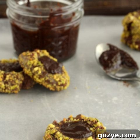 Irish Cream and Pistachio Chocolate Thumbprint Cookies with ganache filling
