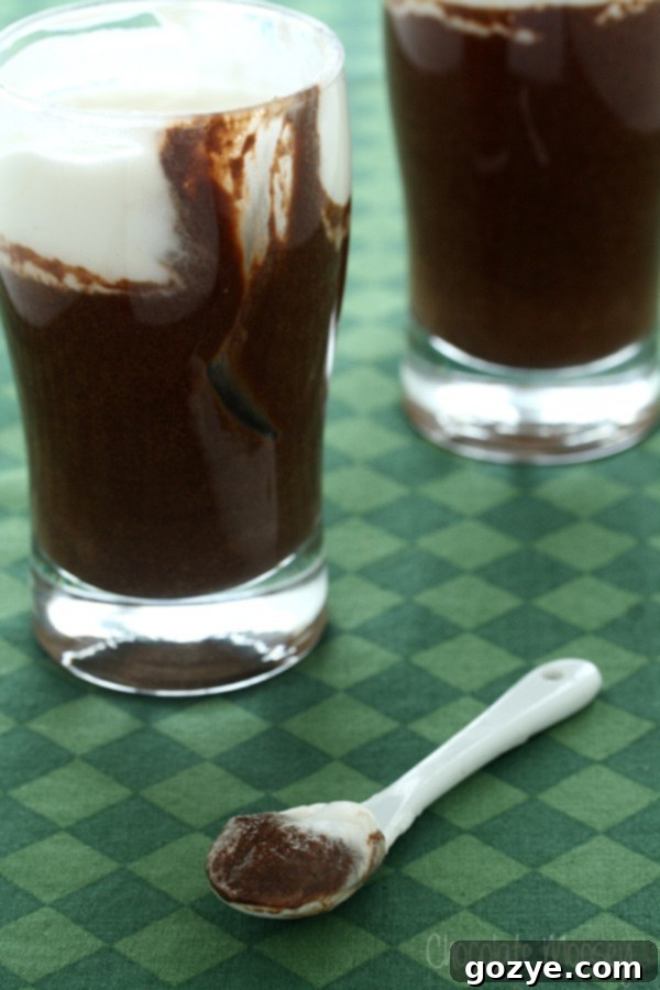 Decadent Duos Chocolate Guinness Mousse 3 Close-up of Guinness Chocolate Mousse in a glass, with a spoon taking a scoop