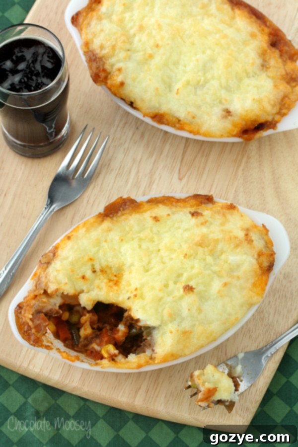Shepherd's Pie with Guinness for Two 2 Shepherd's Pie with a satisfying bite taken out, showcasing the rich filling and creamy topping.