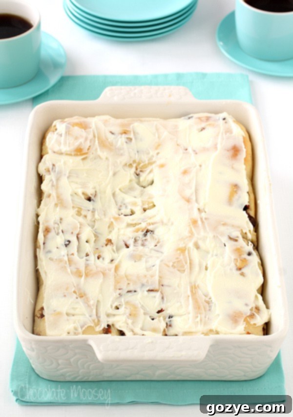 Freshly baked Carrot Cake Cinnamon Rolls cooling on a rack