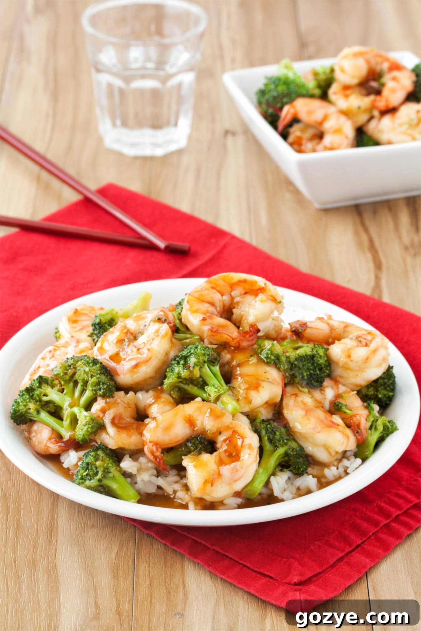 Sweet Chili Shrimp with broccoli and rice on white plate