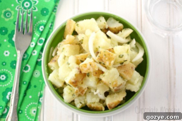 Close-up of vibrant Italian Potato Salad in a green ceramic bowl