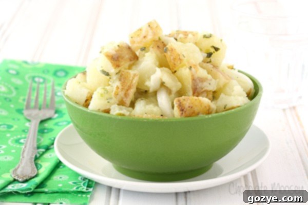 Italian Potato Salad garnished with fresh parsley in a green bowl
