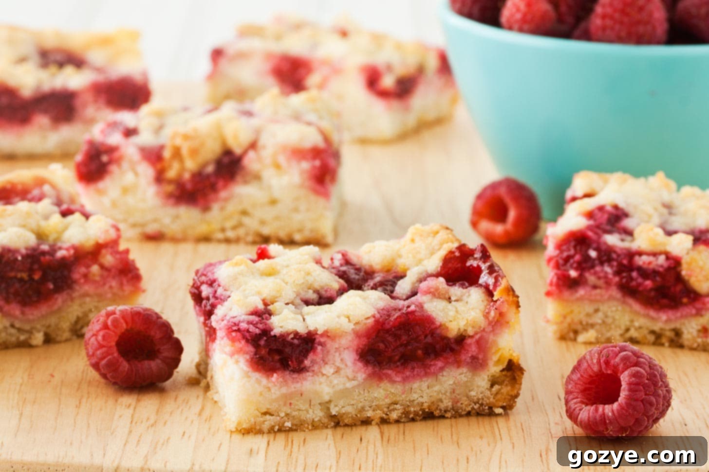 Raspberry Cream Cheese Squares arranged on cutting board