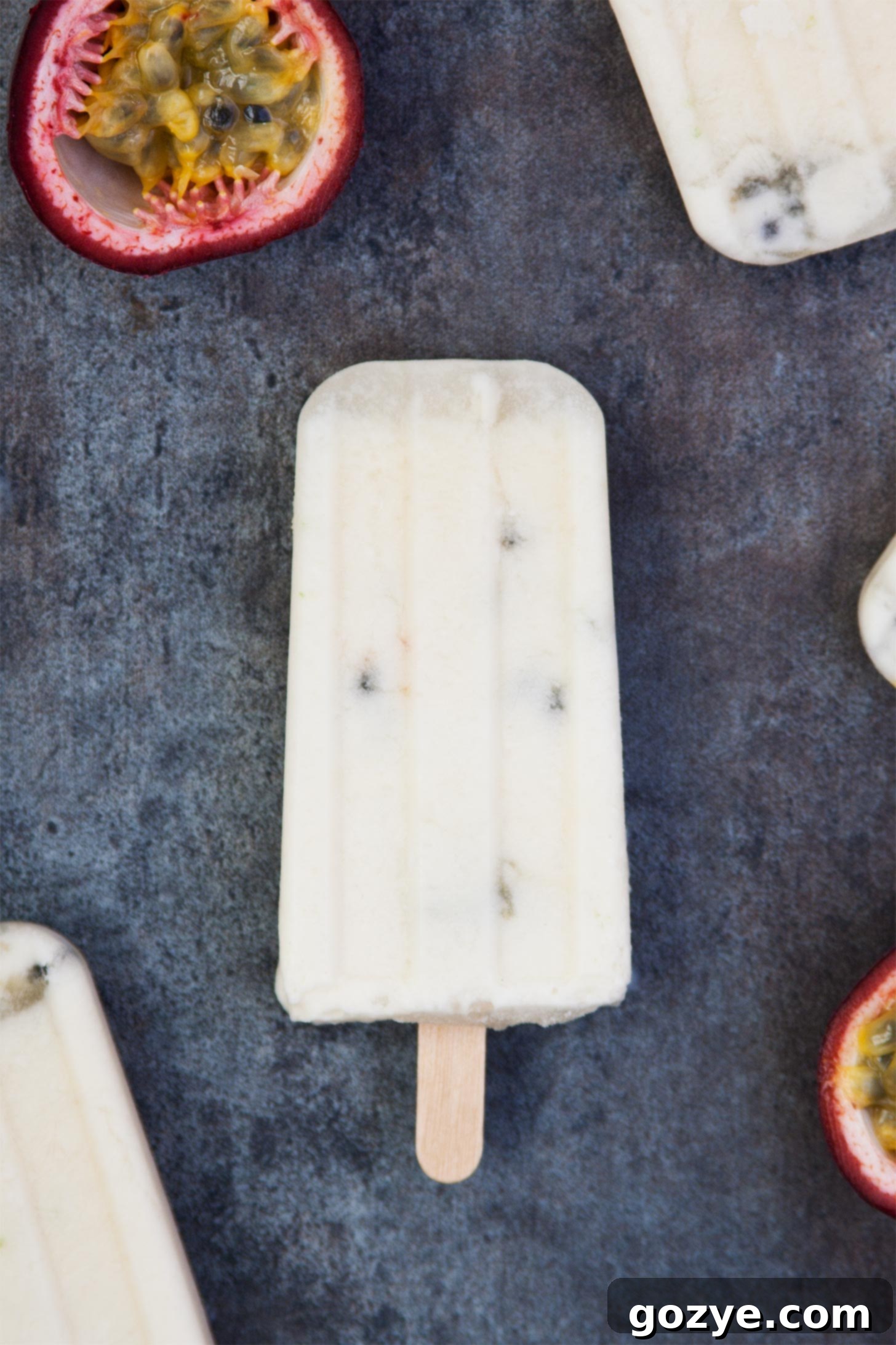Creamy Coconut Popsicles with coconut milk and passion fruit, garnished with fresh passion fruit halves