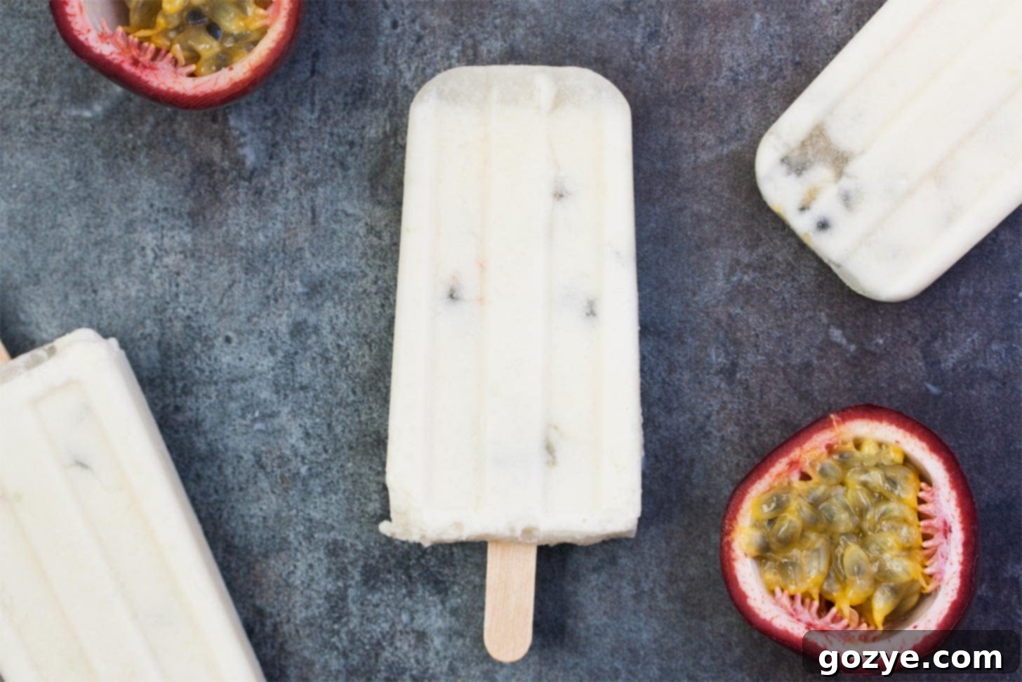 Three Coconut Popsicles recipe with passion fruit and coconut milk, showing their light color against a tropical background