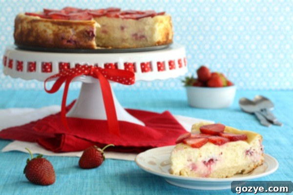 Strawberry Shortcake Cheesecake with fresh strawberries and sponge cake crust
