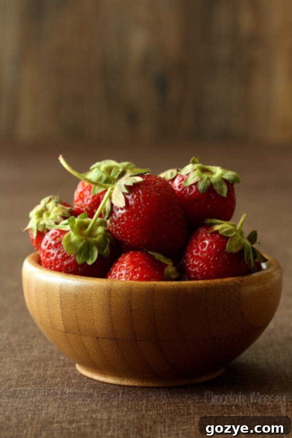 Close-up of fresh, ripe strawberries, key ingredient for homemade strawberry layer cake