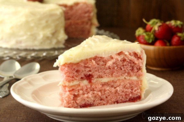 The joy of frosting a two-layer strawberry cake from scratch with smooth cream cheese frosting