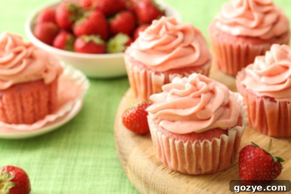A beautifully frosted homemade strawberry layer cake, ready to be sliced and served