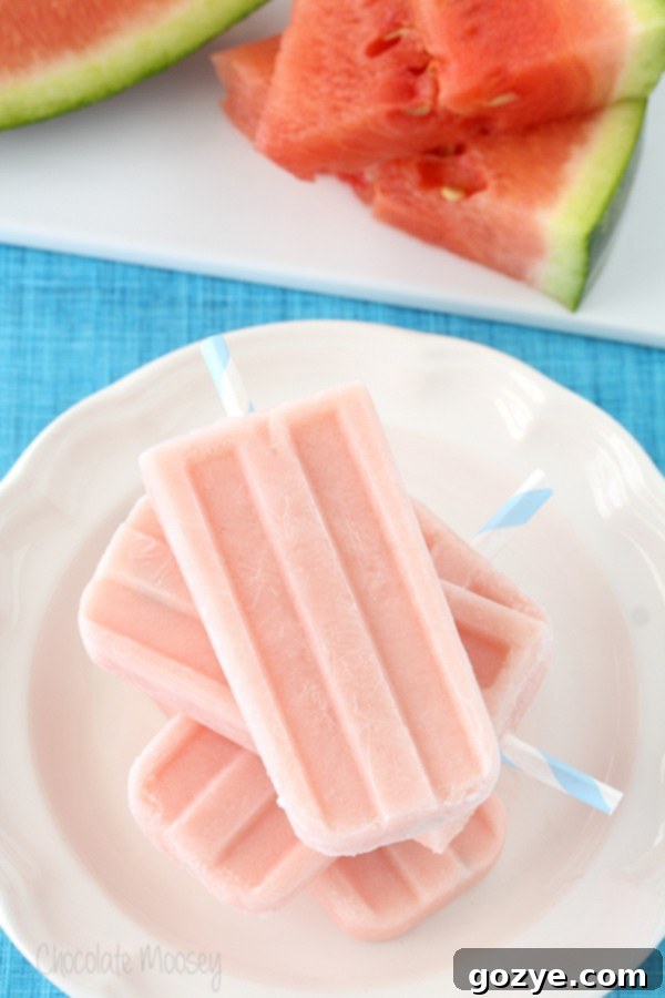 Close-up of Watermelon Pops stacked on a white plate, highlighting the smooth, frozen texture