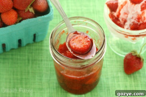 Strawberry Sauce in a jar with a spoon