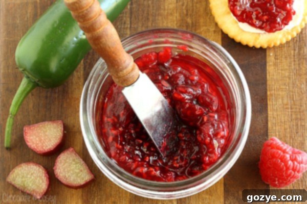 Raspberry Jalapeno Jam in a jar with a knife