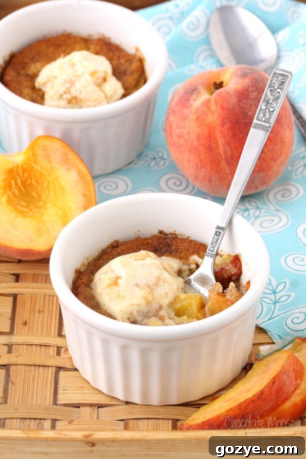 White ramekin with spoon inside peach cobbler