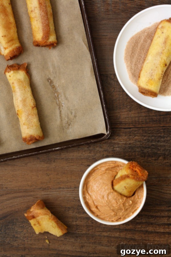 Heavenly Pumpkin Cheesecake French Toast Spirals 6 A Pumpkin Cheesecake French Toast Roll Up being dipped into a bowl of creamy Pumpkin Spice Dipping Sauce, illustrating the delightful interactive eating experience