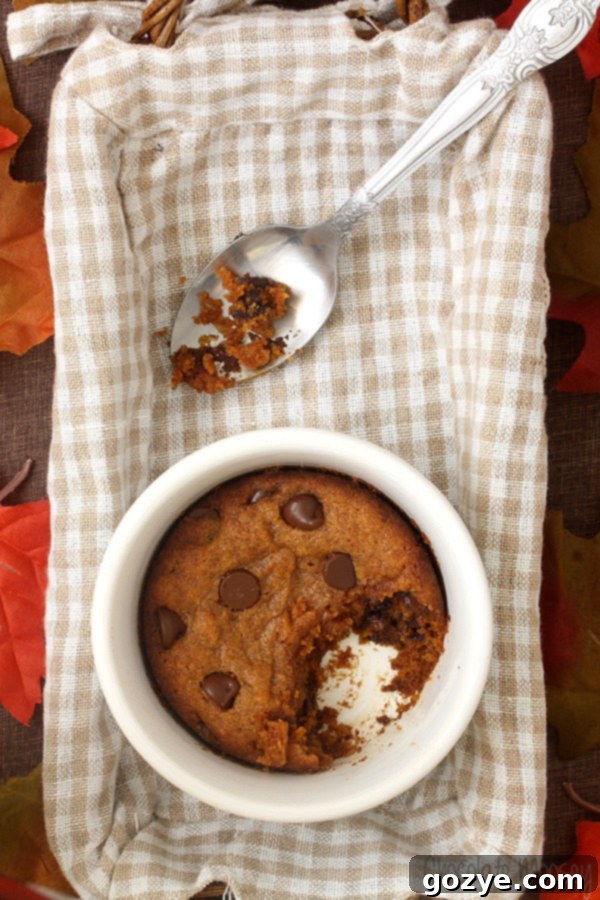 Delicious Single Serving Pumpkin Chocolate Chip Cookie on a white plate, ready to be enjoyed, with a cozy autumn background