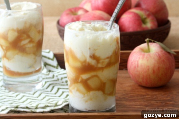 Caramel Apple Cheesecake with a spoon in a parfait glass