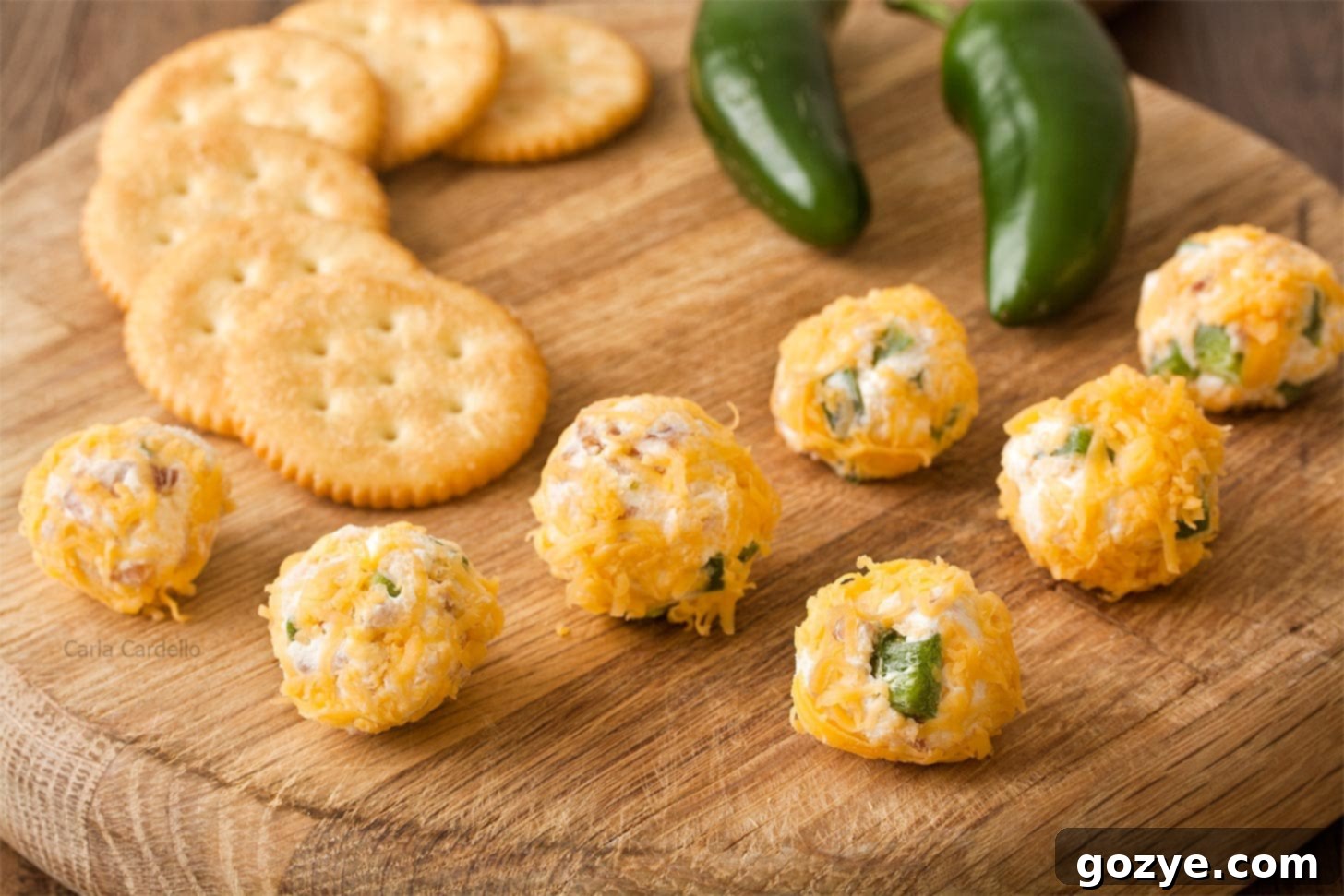 Jalapeno Popper Party Bites 5 Cheese ball bites on thick wooden cutting board