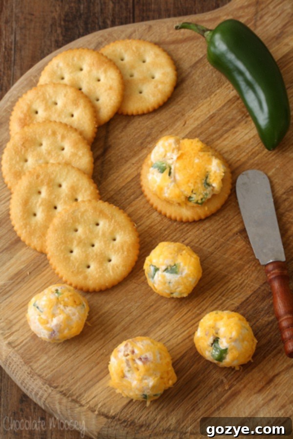 Jalapeno Popper Party Bites 7 Cheese ball bites on thick wooden cutting board