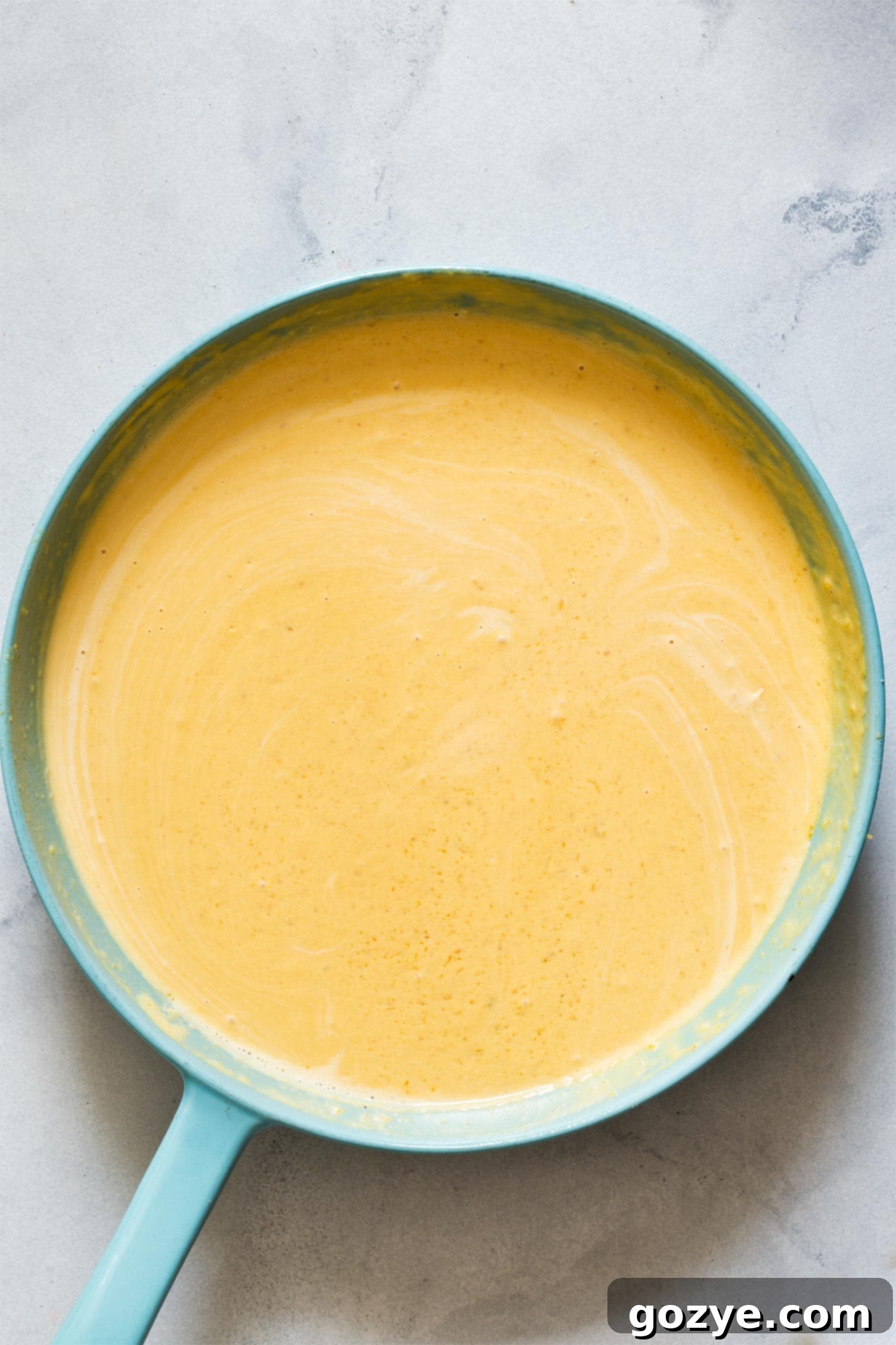 Blended butternut squash alfredo sauce in a skillet, smooth and creamy