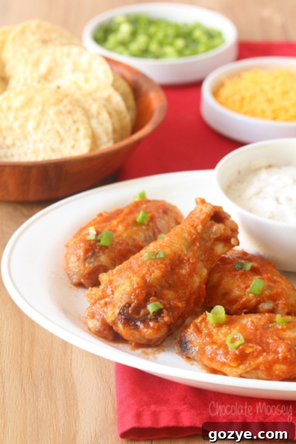 Saucy Taco Baked Chicken Wings, coated in a vibrant, homemade taco sauce with melted cheese, ready to be served