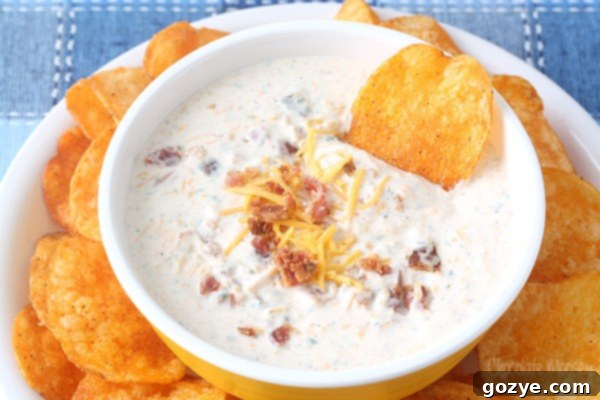 Loaded Bacon Cheddar Ranch Dip 4 Bacon Ranch Cheese Dip with potato chip in bowl