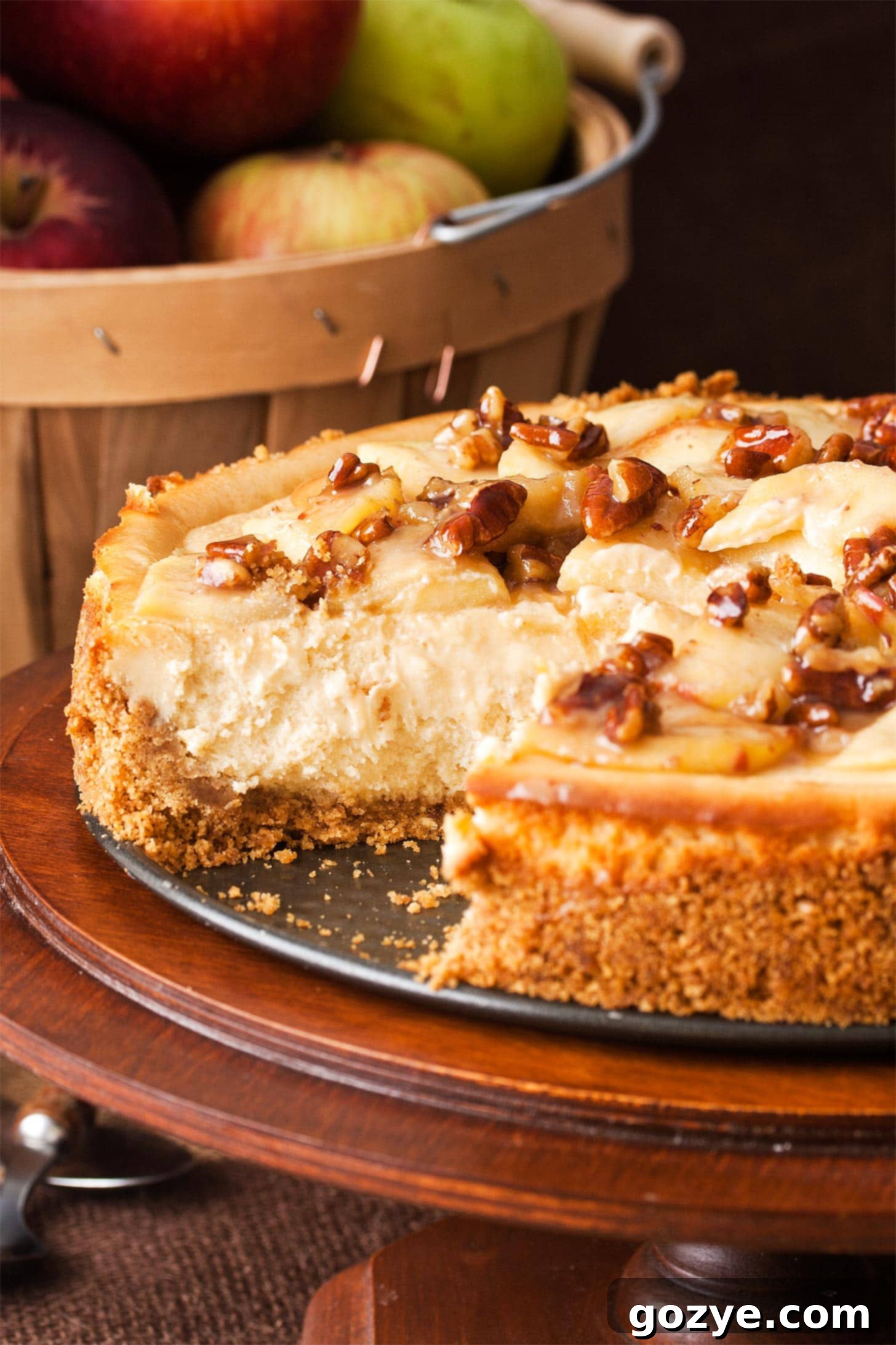 Close up of caramel apple cheesecake with a slice missing