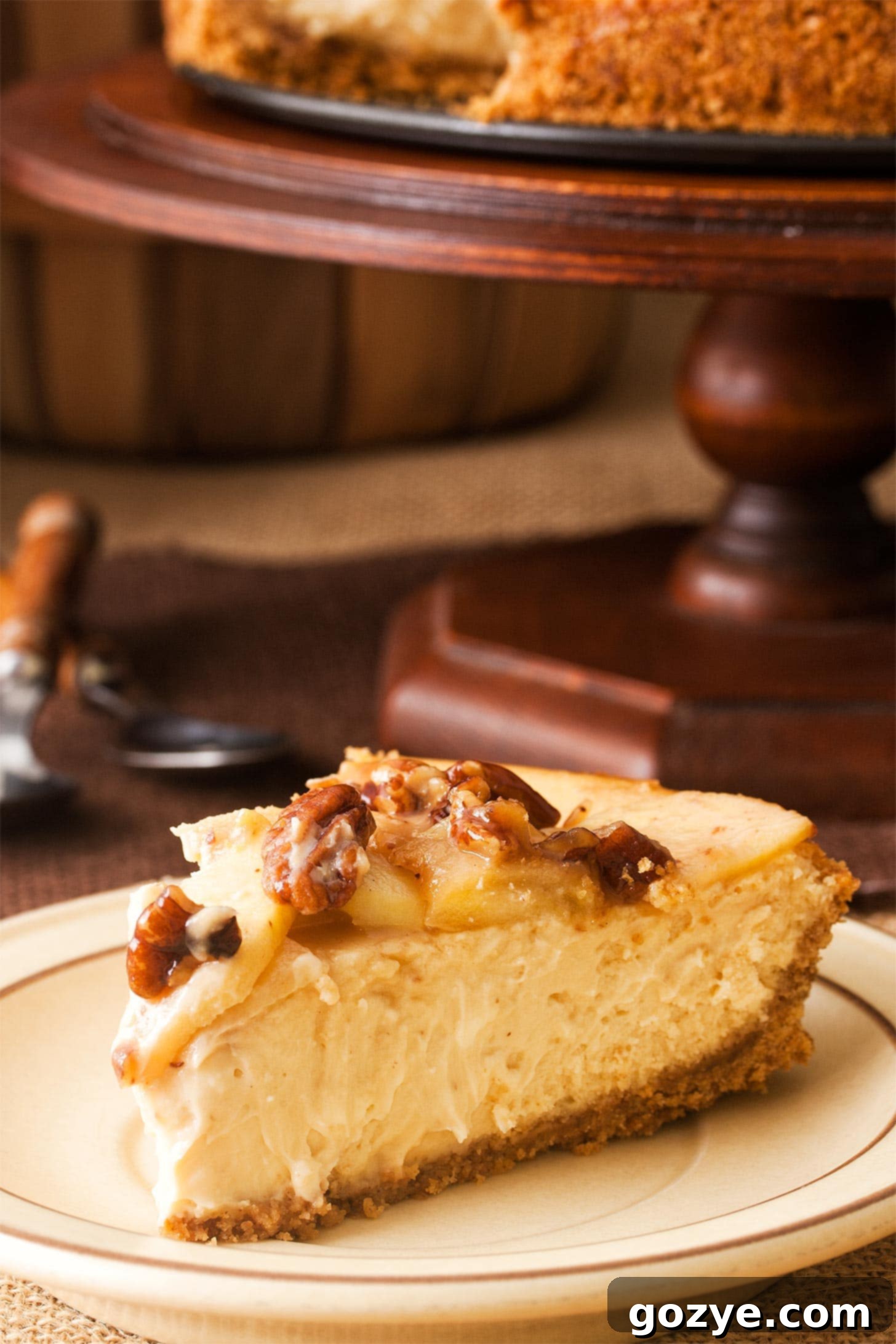 Slice of apple and caramel cheesecake on a brown plate