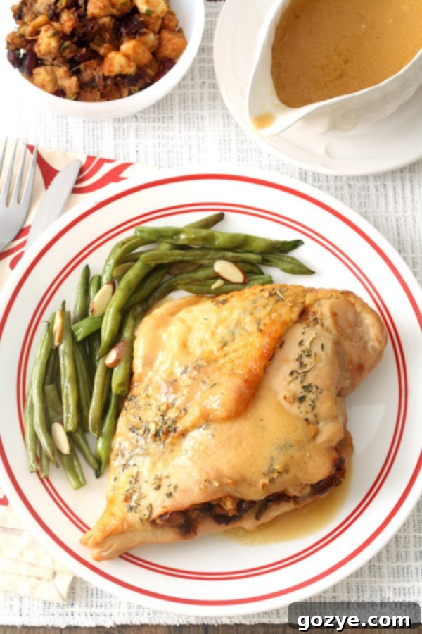 Stuffed turkey breast on plate with green beans