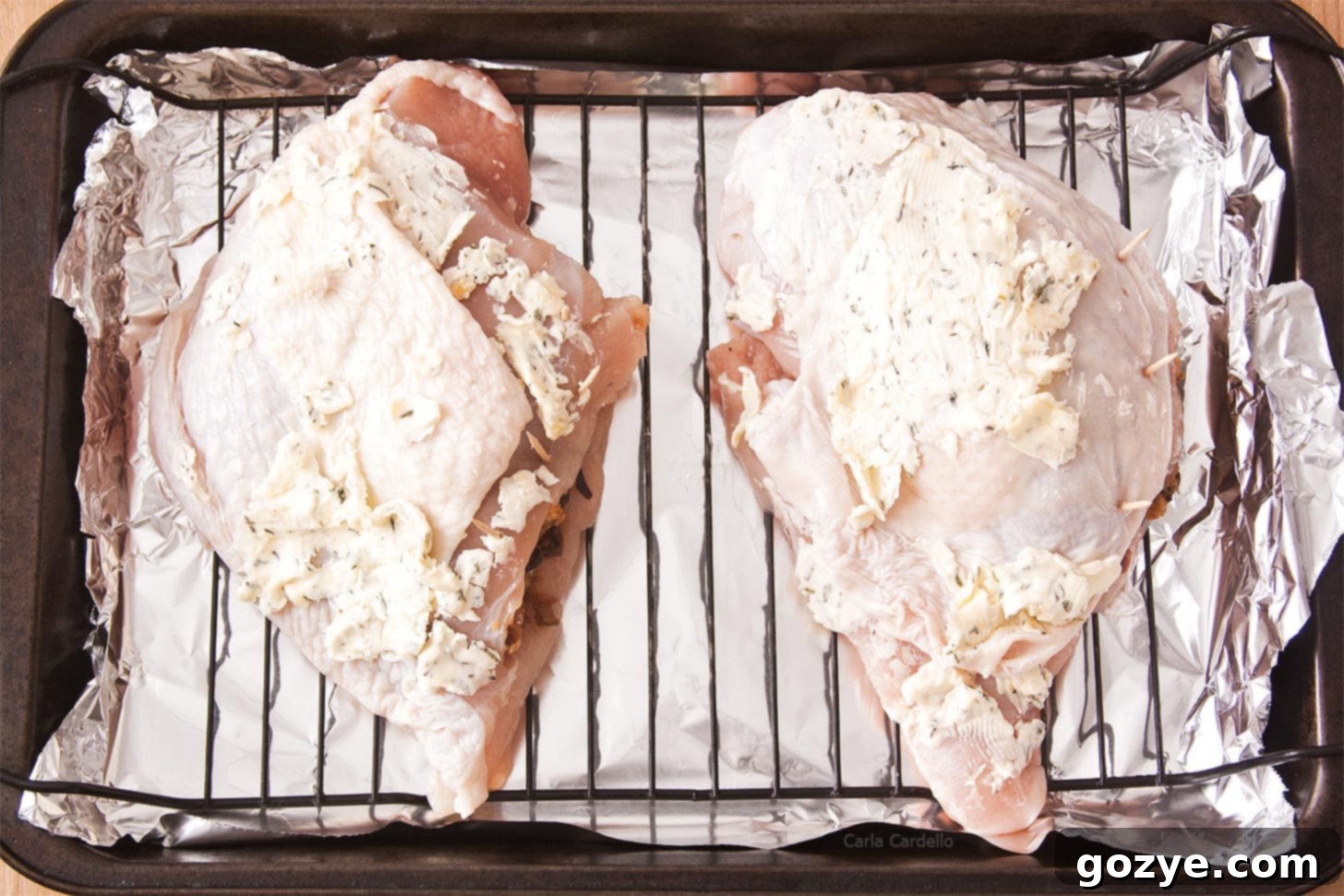 Two turkey breasts on roasting rack in pan