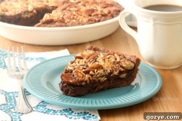 A top-down close-up view of a slice of German Chocolate Pecan Pie, showcasing its rich, layered texture on a teal plate.