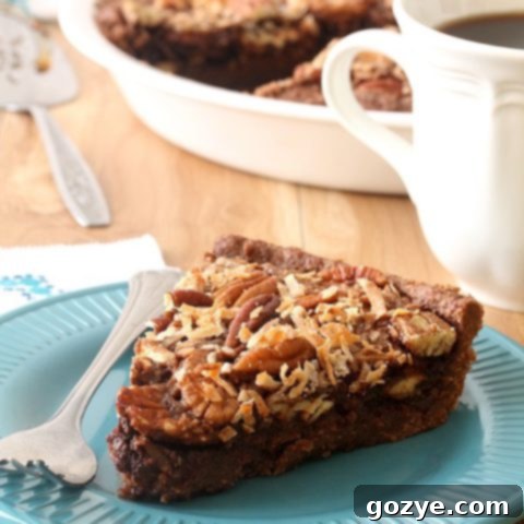 A whole German Chocolate Pecan Pie, glistening with its rich, baked filling and pecan-coconut topping, resting in a classic pie dish.