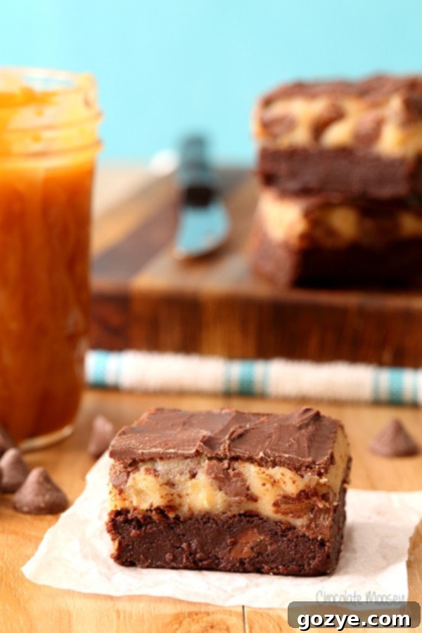 Overhead view of Caramel Chocolate Chip Cookie Dough Brownies cut into neat squares, ready for serving.