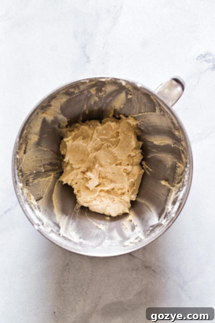 Making chocolate chip cheeseball recipe by beating ingredients in a bowl