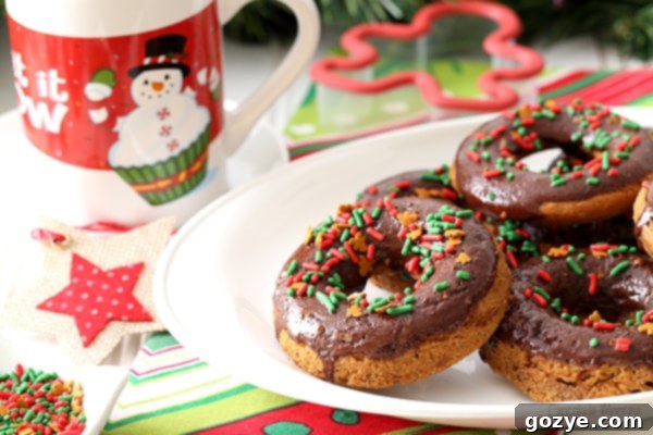 Unfrosted Chocolate Gingerbread Baked Doughnuts cooling in a doughnut pan before glazing