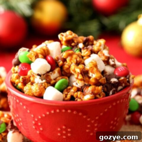 Festive Christmas Popcorn 5 Christmas Popcorn in red bowl with mini marshmallows, M&Ms, and chocolate