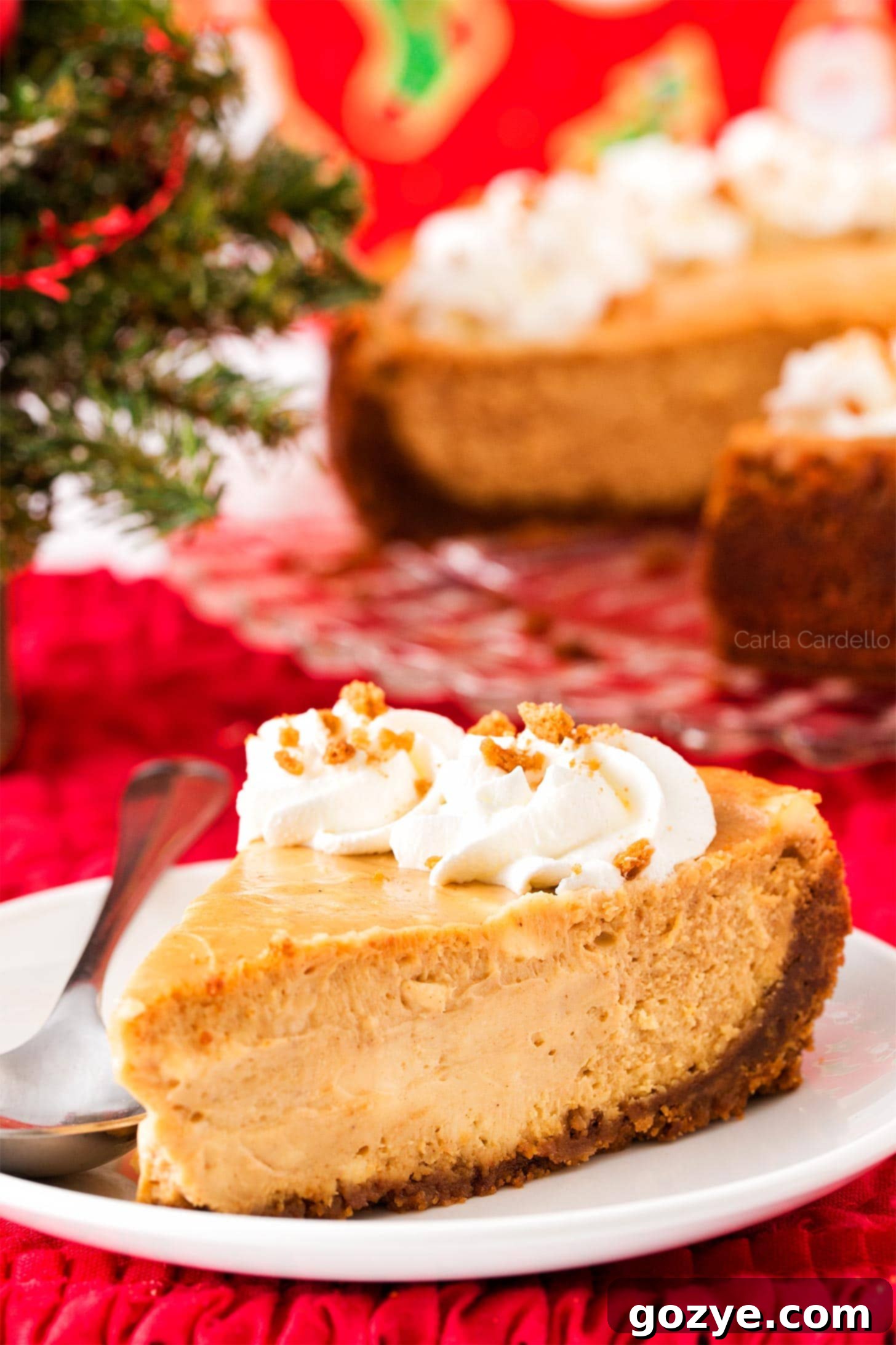 Festive Gingerbread Cheesecake 2 Slice of Gingerbread Cheesecake on white plate with Christmas background