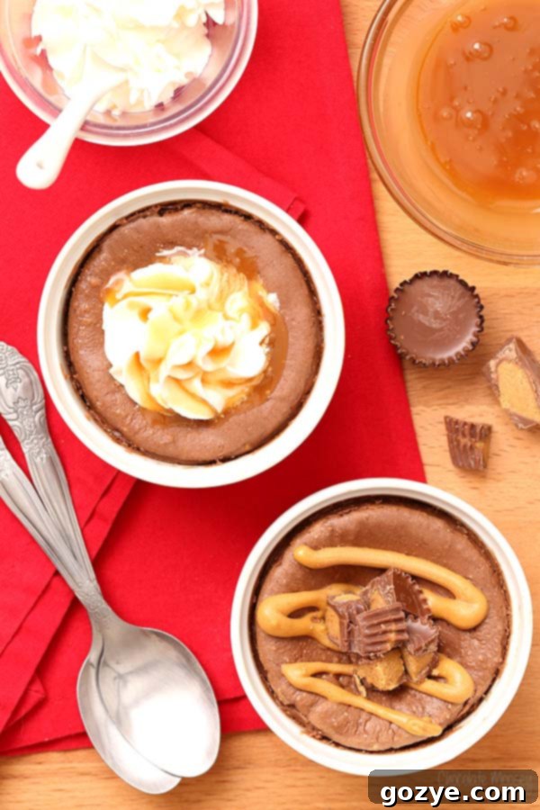 Mini Chocolate Cheesecake For Two with caramel and peanut butter cup, a detailed shot of the decadent topping on a chocolate cheesecake