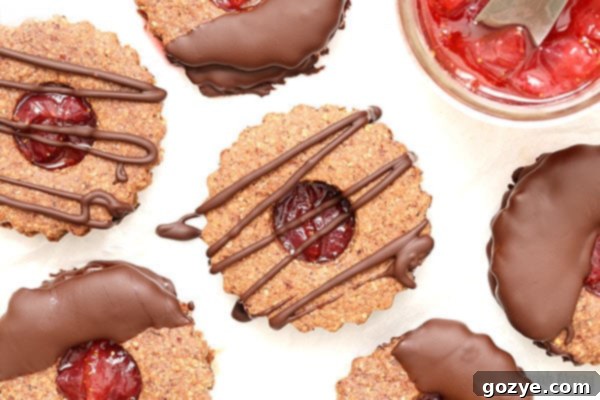 Chocolate Covered Strawberry Linzer Cookies made with hazelnut flour and strawberry jam
