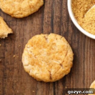 Cream Cheese Cookies being rolled in graham cracker crumbs